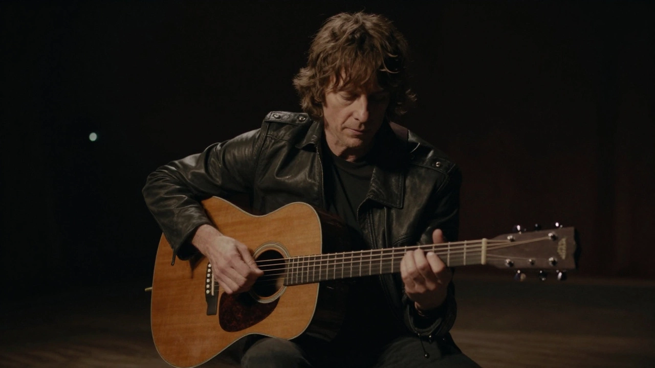 Pete Townshend playing acoustic guitar in a dimly lit, intimate setting